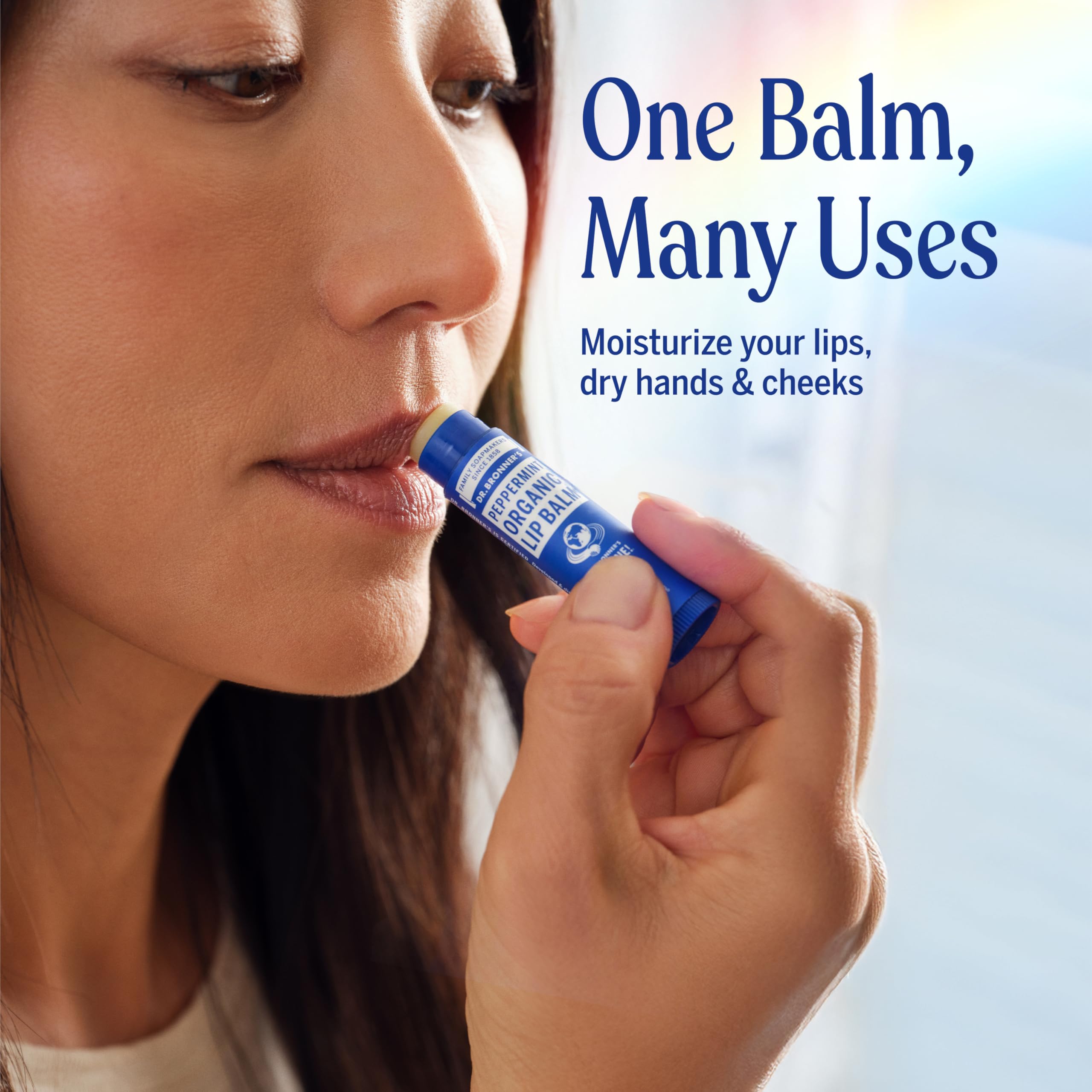 Dr. Bronner's lip balm applied to dry lips for hydration.