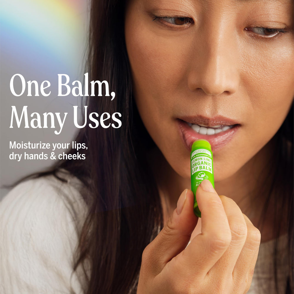 Applying Dr Bronner's Lemon Lime lip balm on lips during cold weather