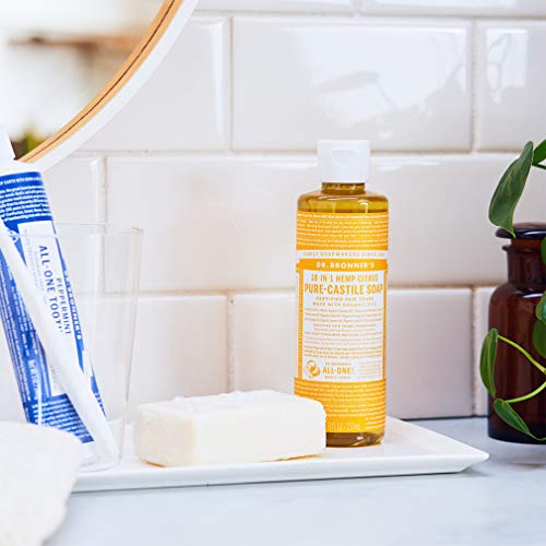 Pouring Dr. Bronner's Citrus Pure-Castile Soap for versatile cleaning and body care.
