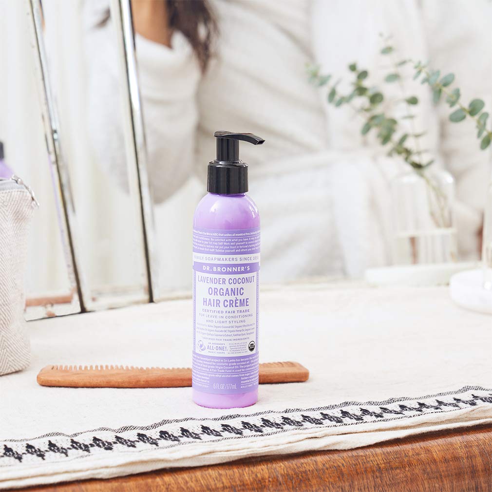 Dr. Bronner's Organic Hair Crème ingredients bottle displays jojoba and hemp oils for moisturized hair.