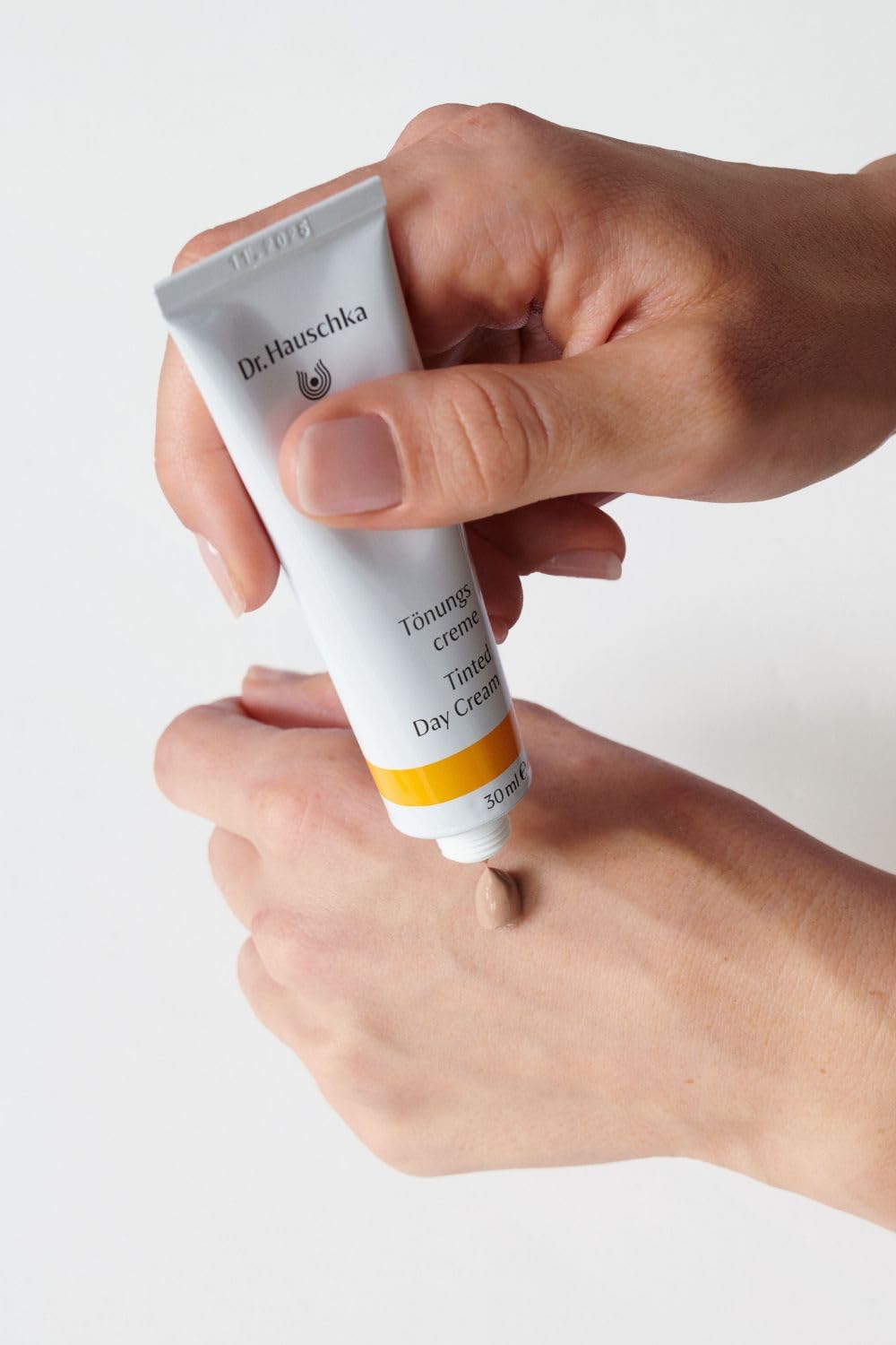 Dr Hauschka tinted day cream being applied for a subtle glow on face