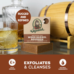 Hand holding Dr. Squatch Wood Barrel Bourbon bar forming creamy lather.