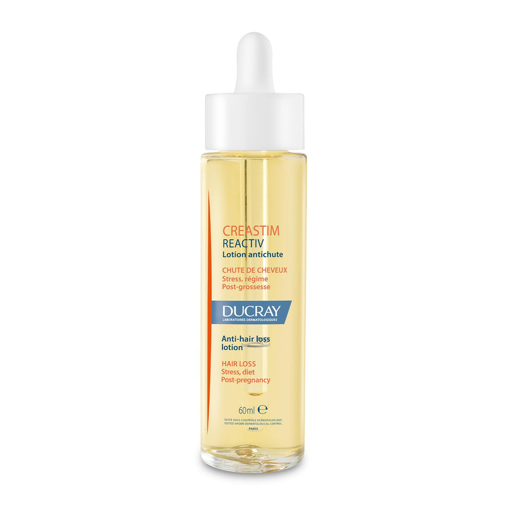 Ducray Creastim Reactiv bottle close-up for scalp care routine.