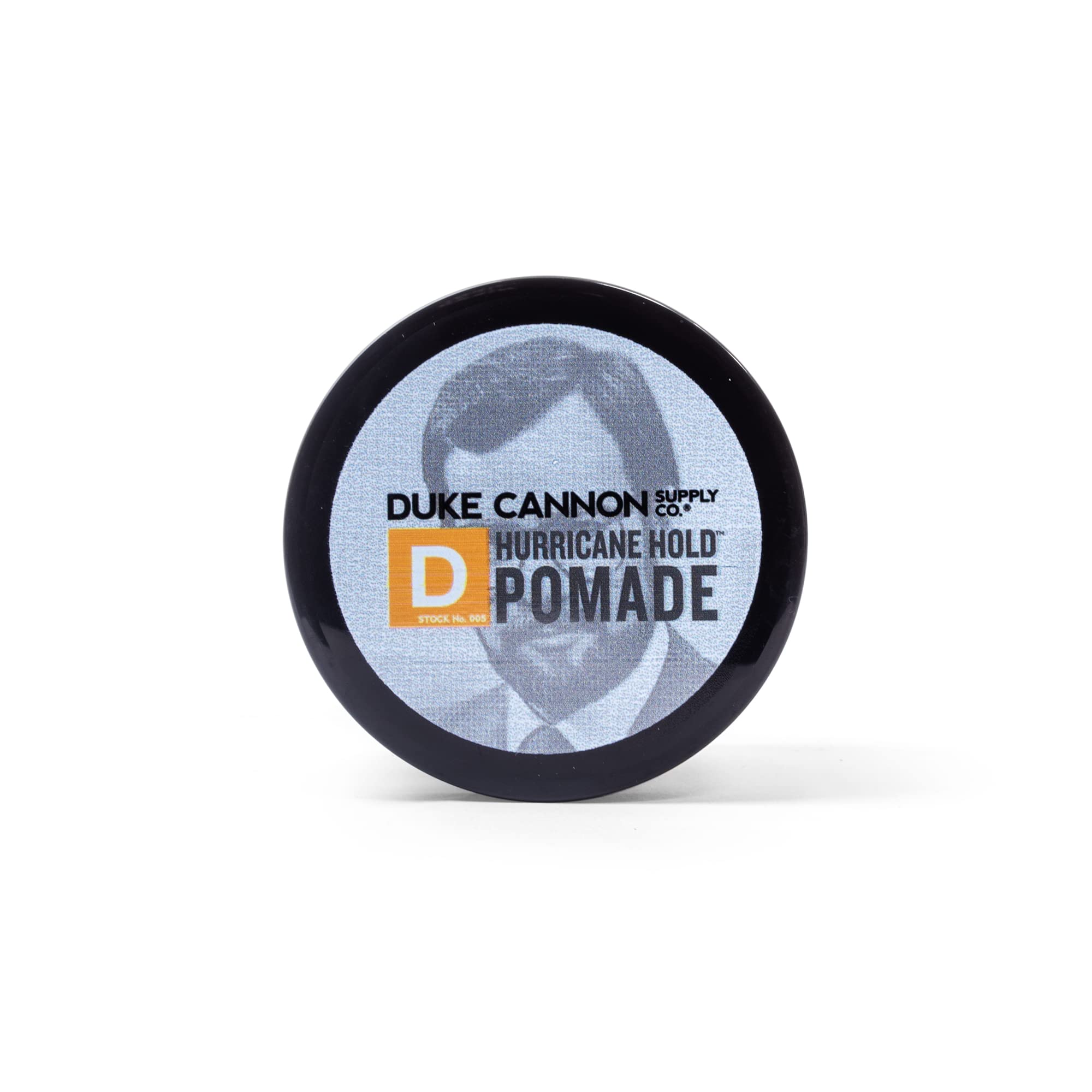 Duke Cannon News Anchor Hurricane Hold Pomade being scooped from the jar for short-to-medium hair control.