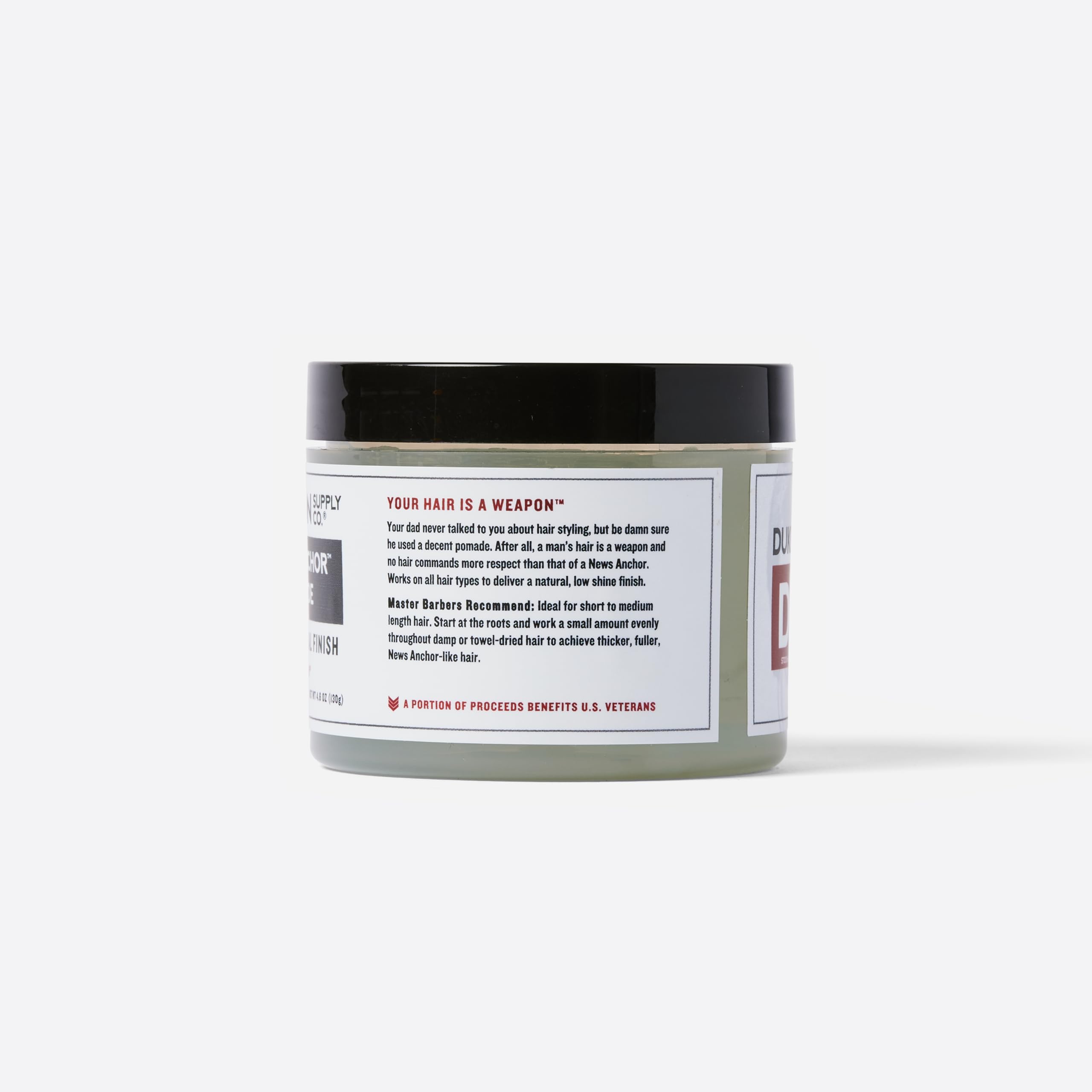 Duke Cannon News Anchor Pomade brand logo close-up signals trusted grooming for busy mornings.