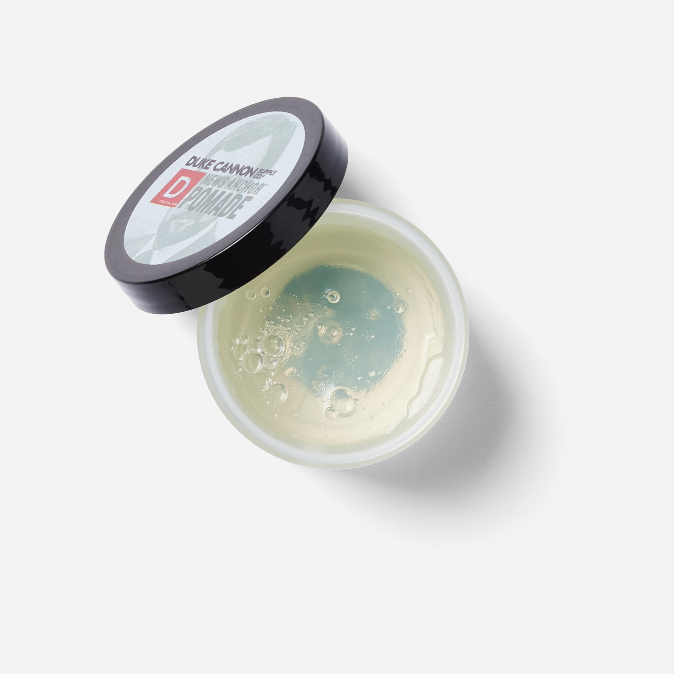 Duke Cannon News Anchor Pomade natural matte finish swatch illustrates low shine, polished look.