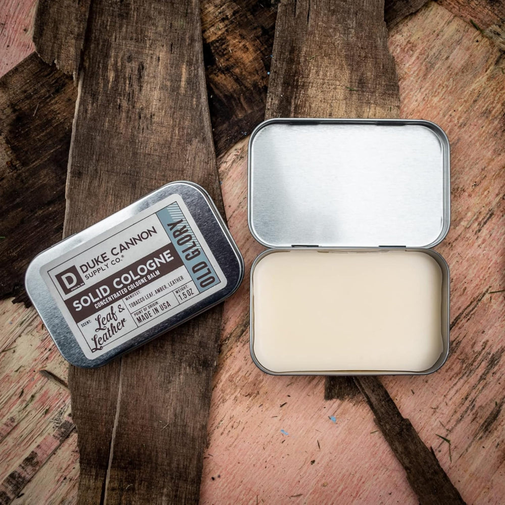 Duke Cannon Old Glory balm close-up highlighting tobacco-amber-leather aroma for daily confidence.