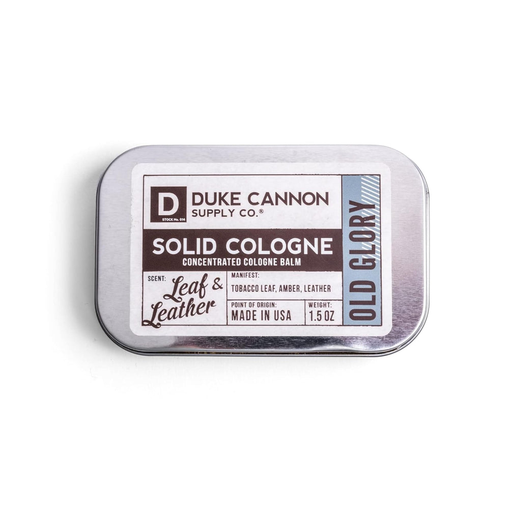 Duke Cannon Old Glory solid cologne tin front view for on-the-go freshness.