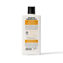Duke Cannon Sawtooth 2-in-1 Hair Wash bottle close-up highlights refreshing alpine-cedar scent.
