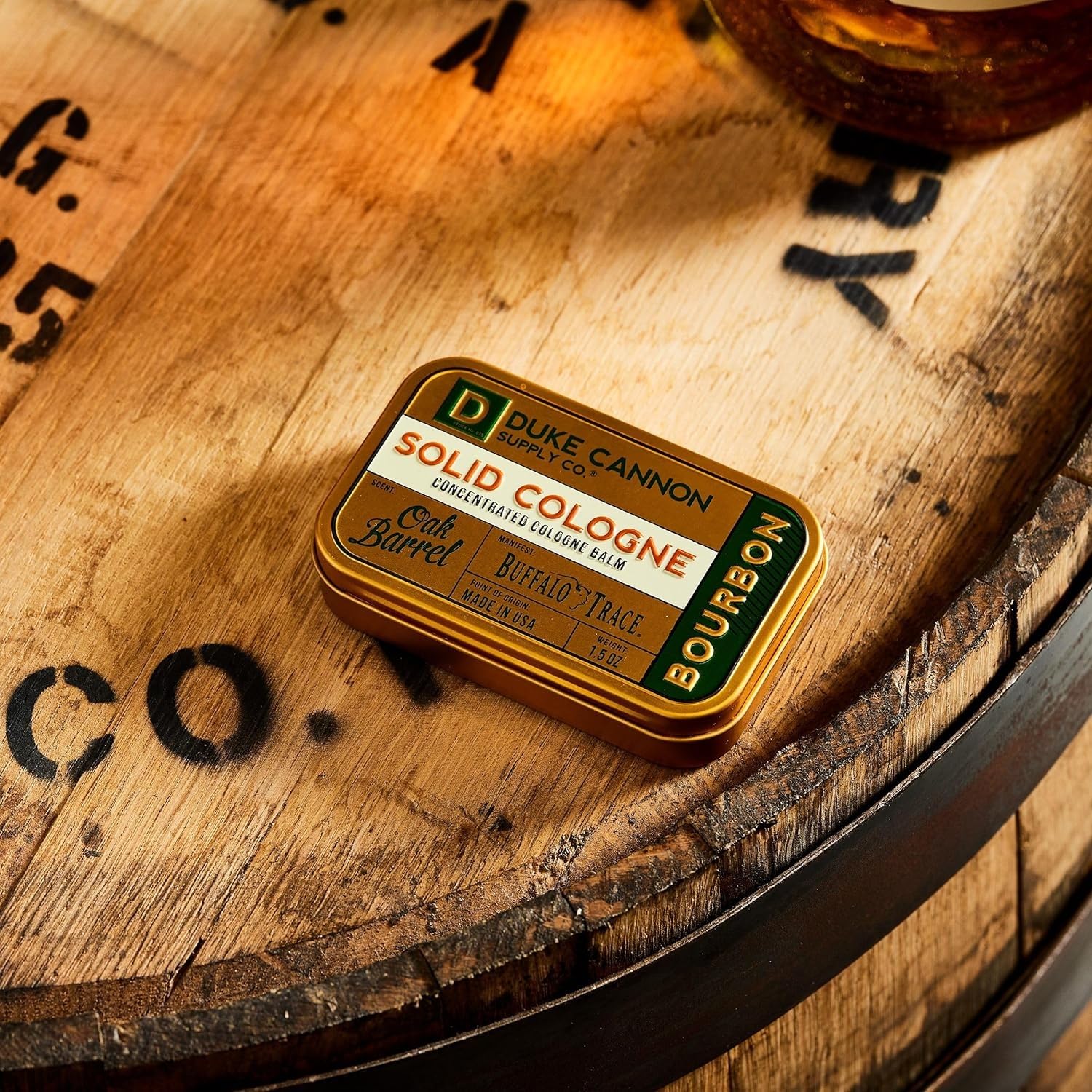 Duke Cannon Bourbon solid cologne travel tin shown for travel-friendliness.