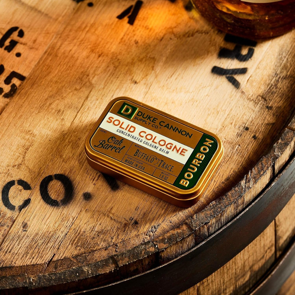 Duke Cannon Bourbon solid cologne travel tin shown for travel-friendliness.