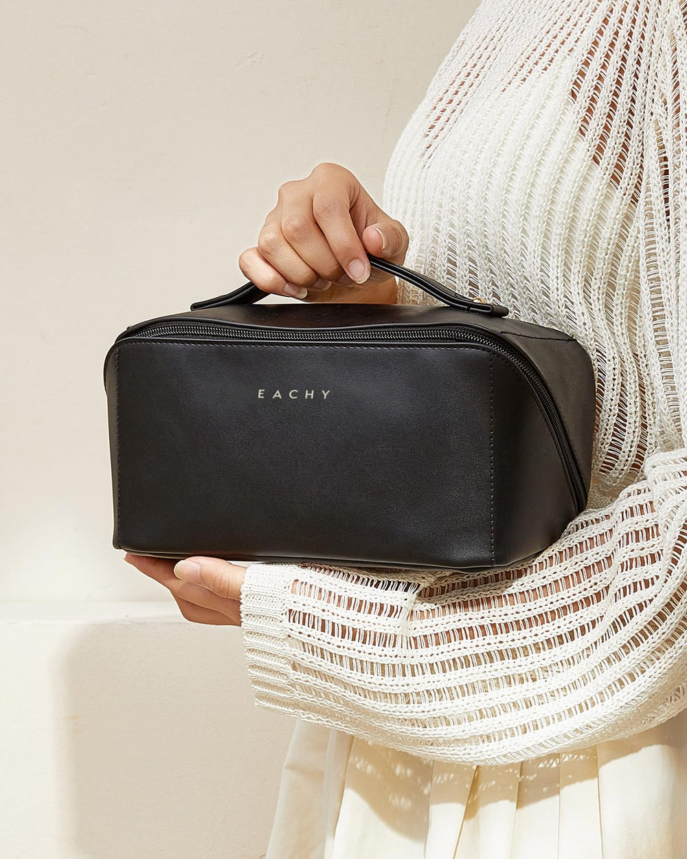 EACHY travel makeup bag black exterior coordinates with travel gear.
