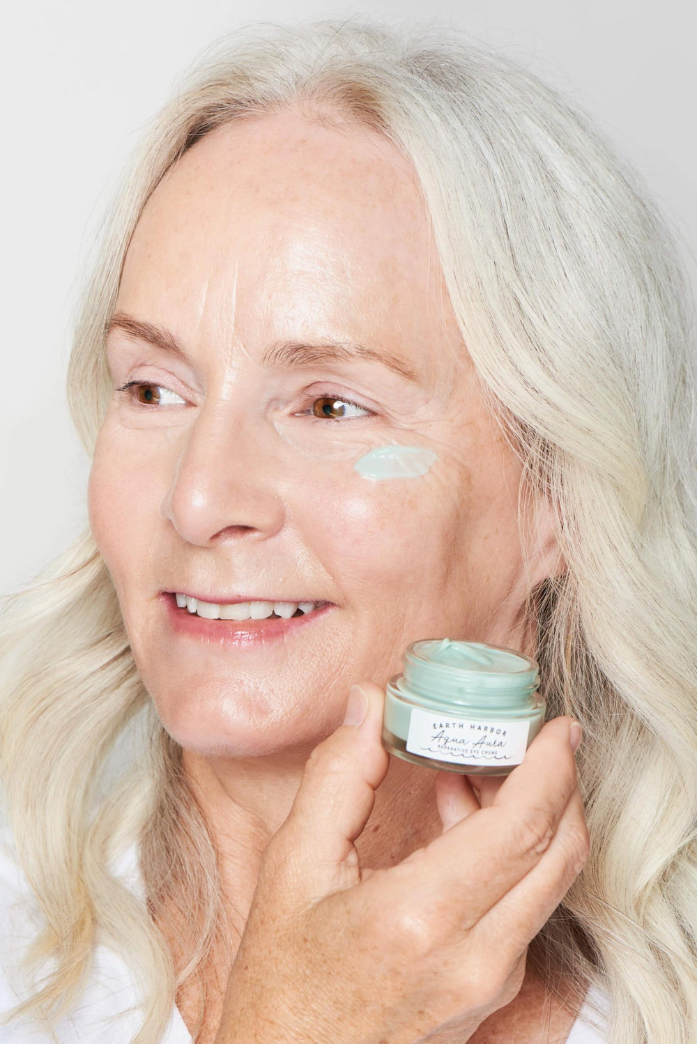 Earth Harbor AQUA AURA eye cream bottle showcasing soothing, brightening eye care