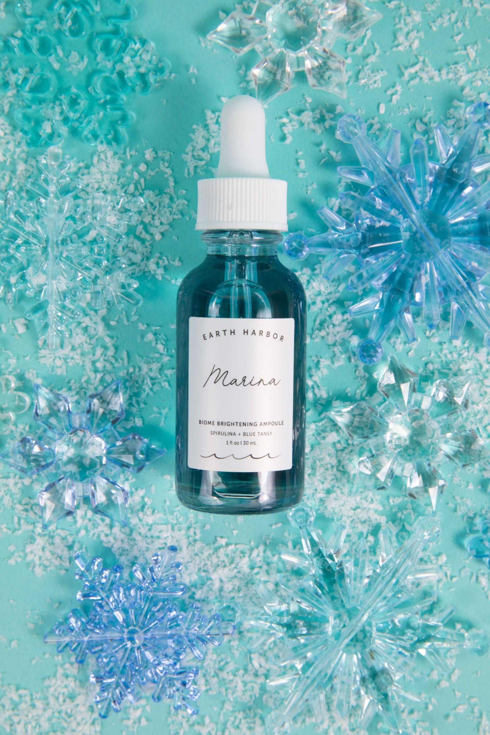 Earth Harbor Marina texture application shows smooth serum layer on skin.