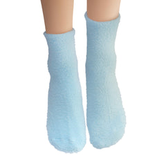 Earth Therapeutics Aloe Socks ready for overnight moisturizing routine beside bed.