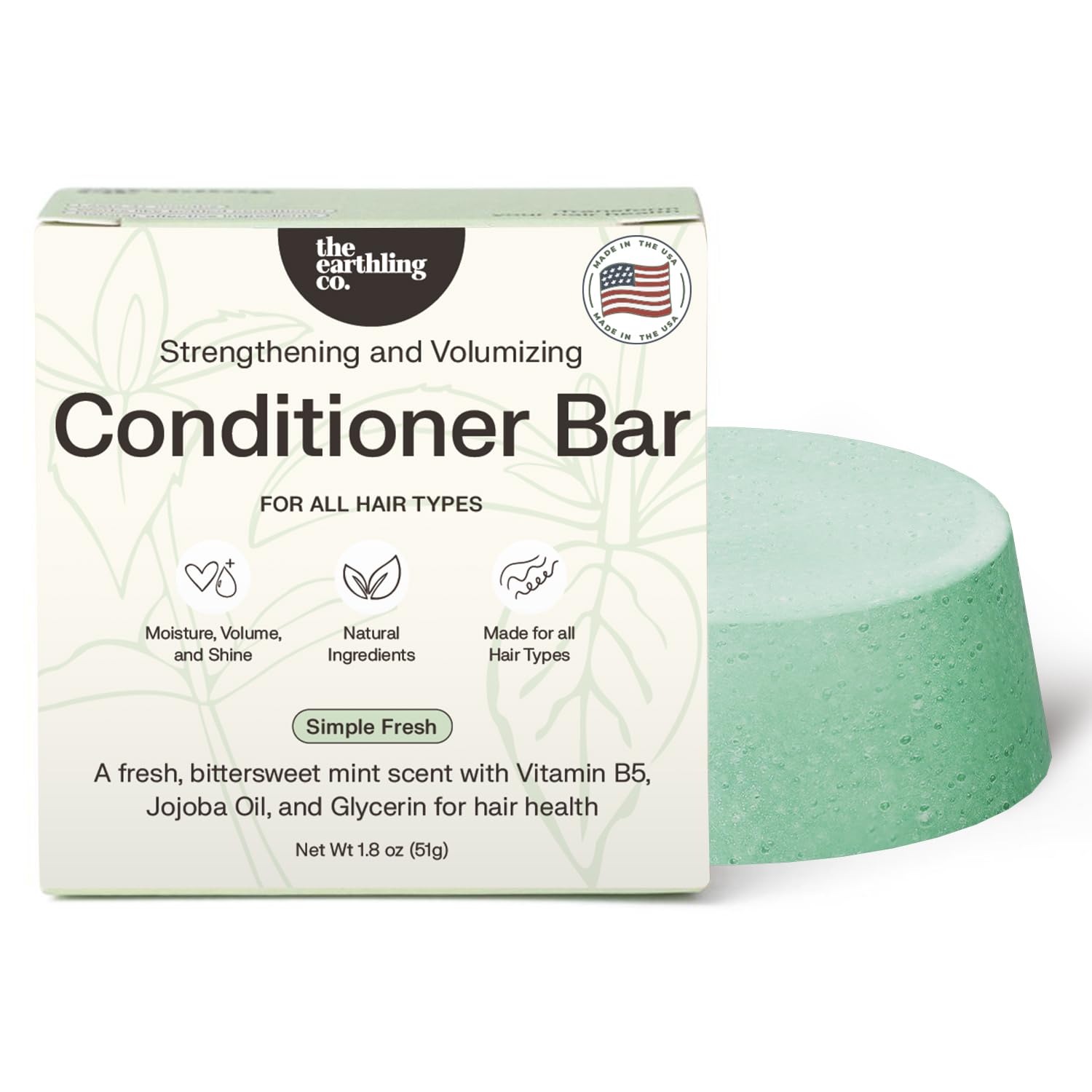 The Earthling Co. conditioner bar in hand demonstrates solid form for easy travel and mess-free conditioning.