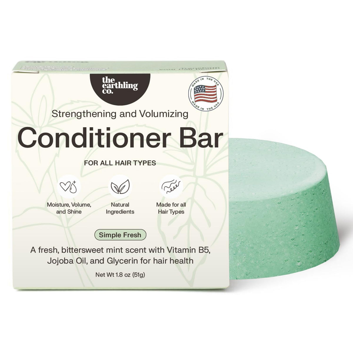 The Earthling Co. conditioner bar in hand demonstrates solid form for easy travel and mess-free conditioning.