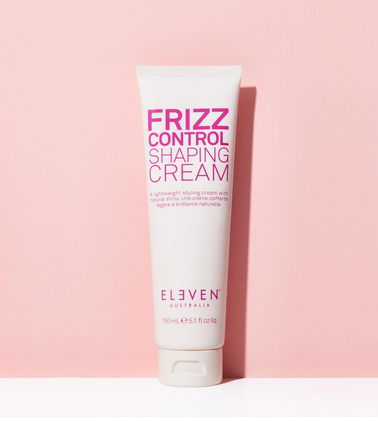 ELEVEN AUSTRALIA Frizz Control Shaping Cream application-hands shows creamy texture and even distribution.