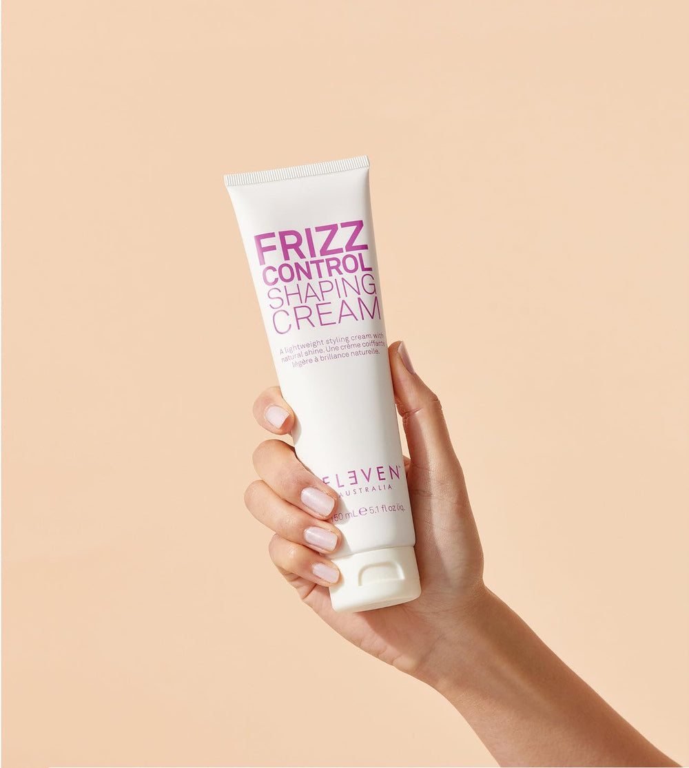 ELEVEN AUSTRALIA Frizz Control Shaping Cream pump-dispense demonstrates precise application for flyaway control.