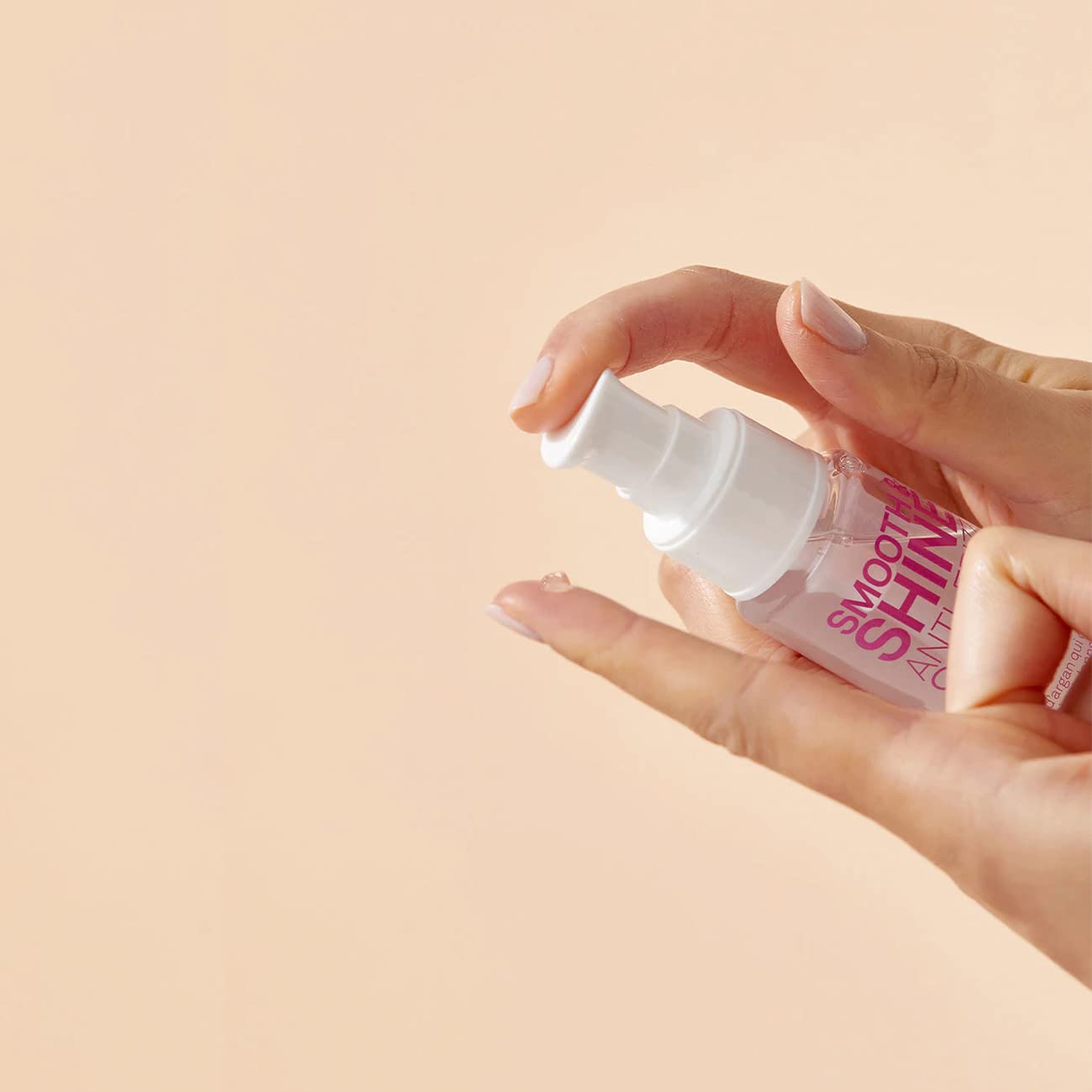 ELEVEN AUSTRALIA Smooth & Shine Serum being applied during blow-dry for a smooth finish.