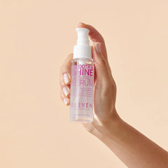ELEVEN AUSTRALIA Smooth & Shine Serum on hair strands with frizz tame and gloss.
