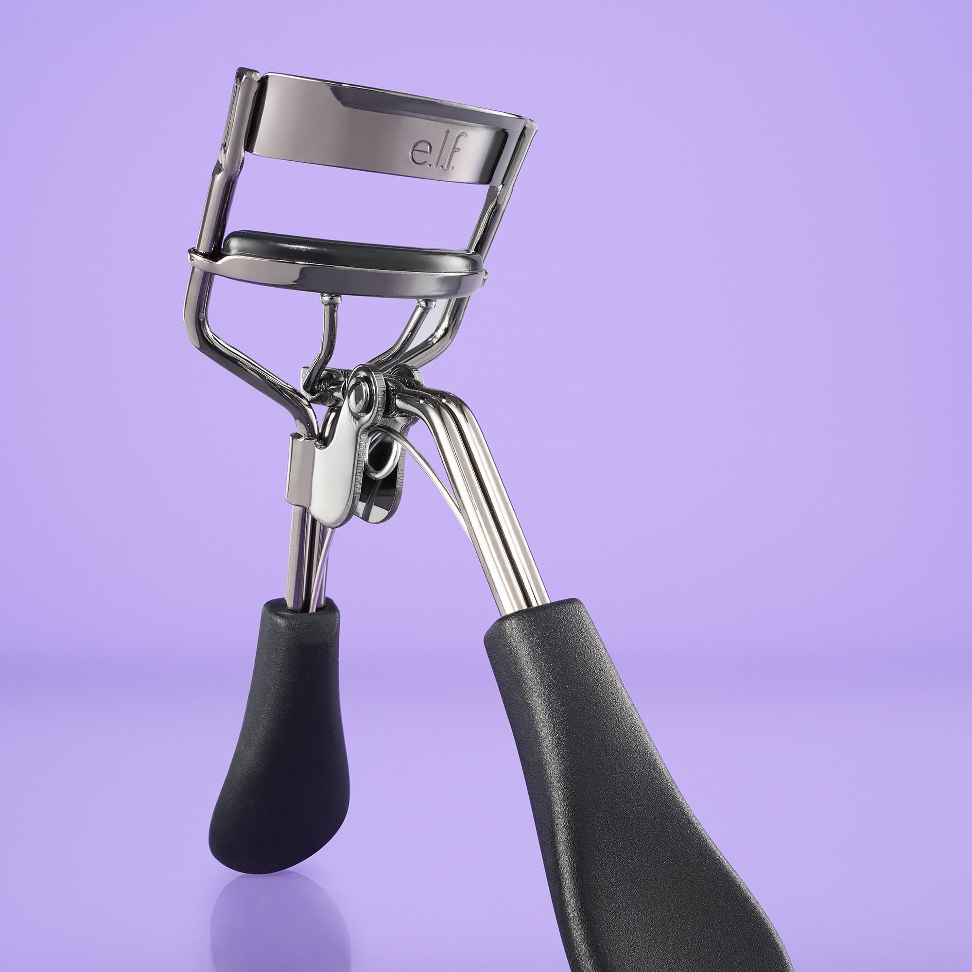 e.l.f. pro eyelash curler held in hand to show ergonomic grip and control