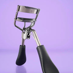 e.l.f. pro eyelash curler held in hand to show ergonomic grip and control