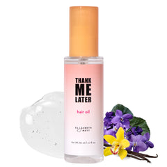 Elizabeth Mott hair oil bottle closeup showing nourishing frizz-control formula.