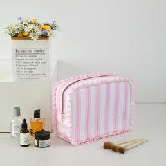 EMBRUNIOICE Stripe Ruffle Makeup Bag open view reveals organized interior for cosmetics.