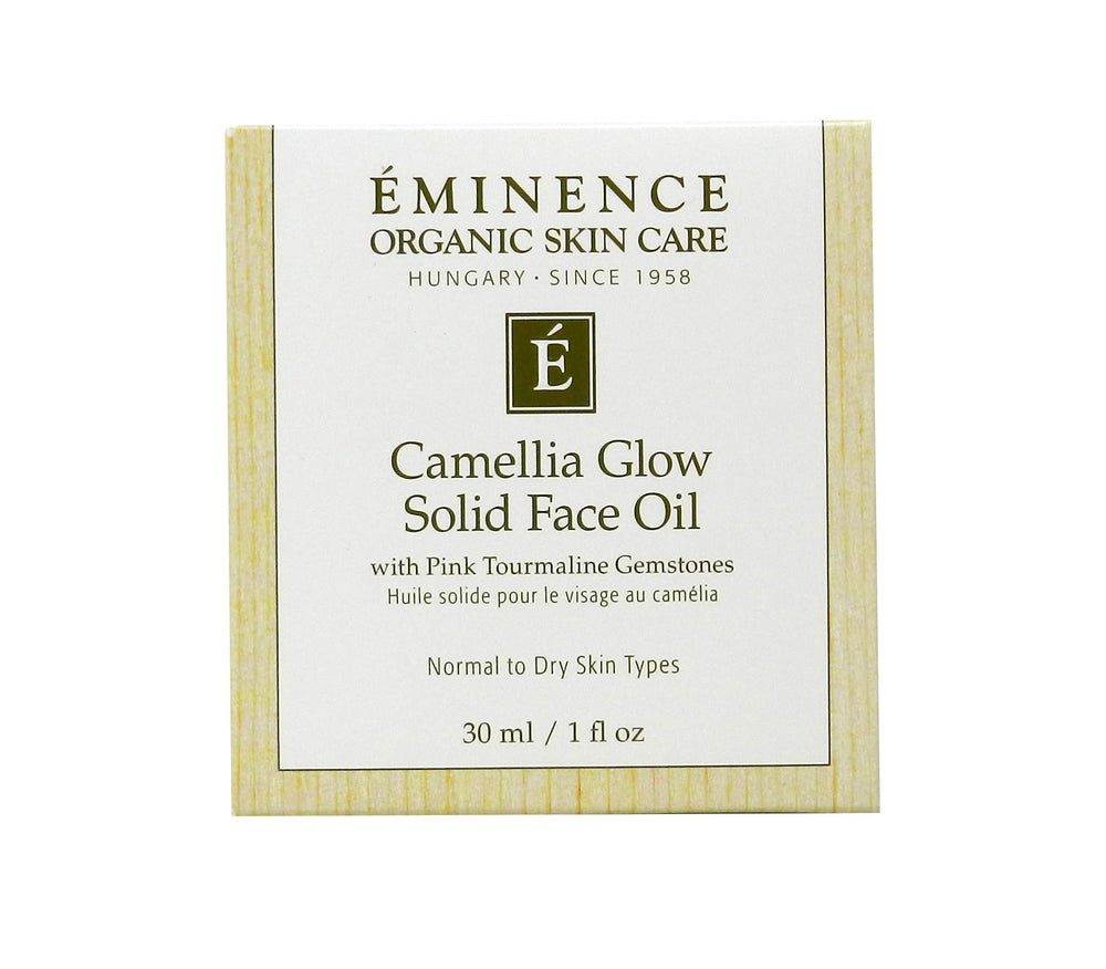 Eminence Camellia Glow solid face oil in palm ready for a soft glow.
