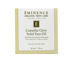 Eminence Camellia Glow solid face oil in palm ready for a soft glow.