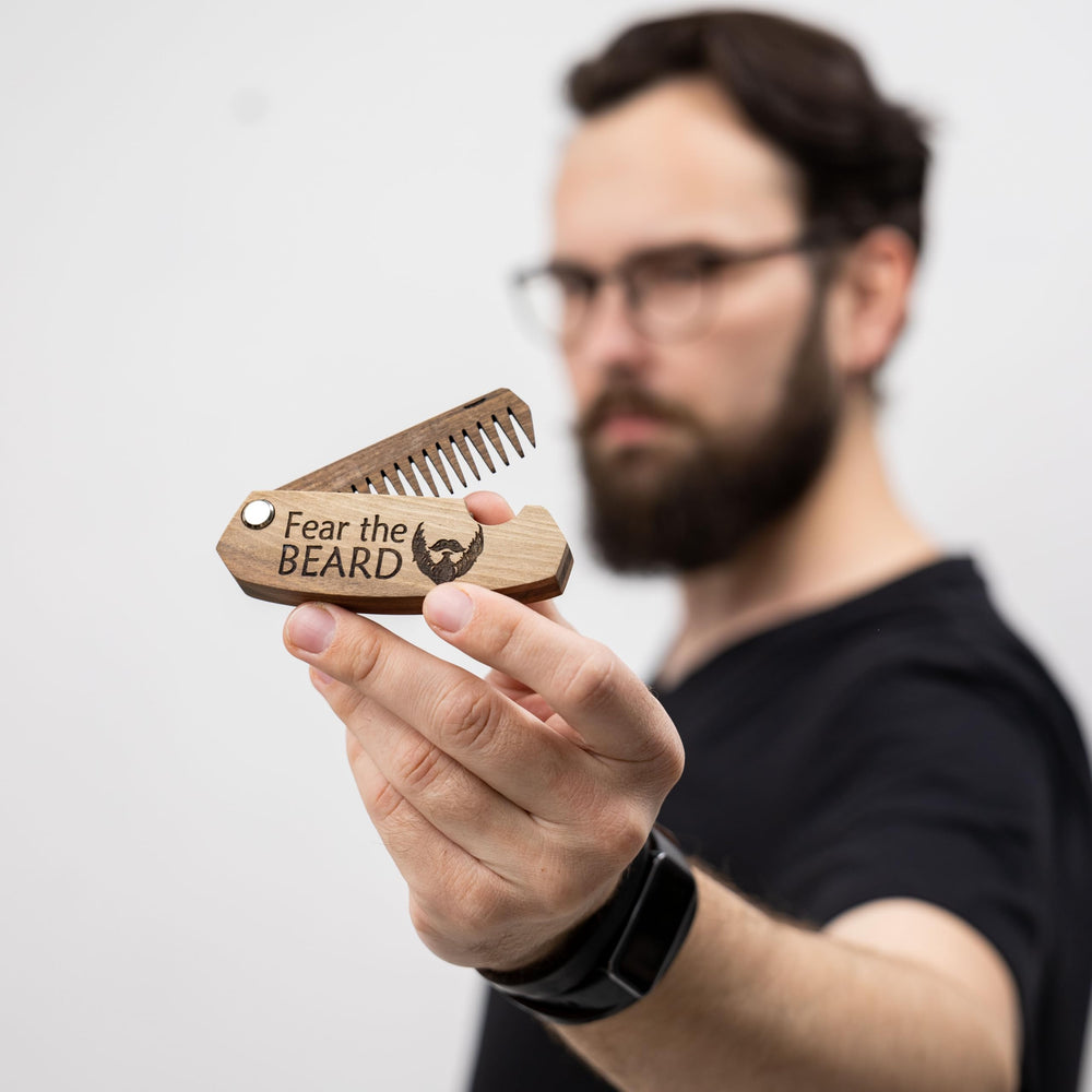 Enjoy The Wood pocket-size beard comb in hand for easy pocket carry.