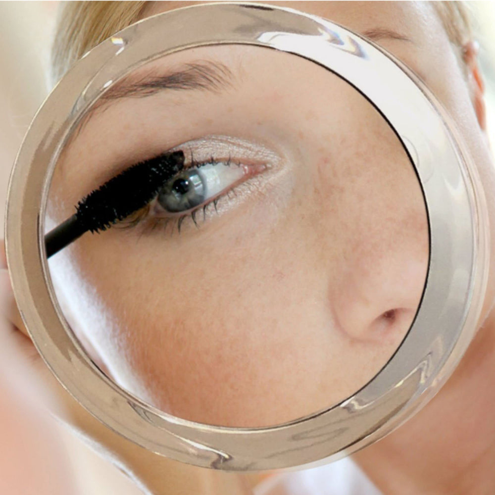 Essential Skin Solutions 15X mirror with three suction cups for secure portable mounting.