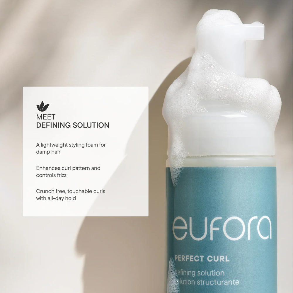 Applying Eufora Perfect Curl Defining Solution to damp hair with scrunch.