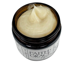 Faith and Grace Organics Face/Body-use balm on forearm demonstrates versatile, non-greasy hydration.