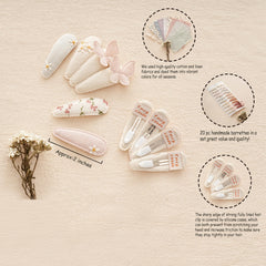 Fancy Clouds neutral fabric snap clip with daisies provides soft touch and versatile styling.
