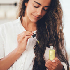 FEIBTH Hair Growth Oil application on scalp during routine.