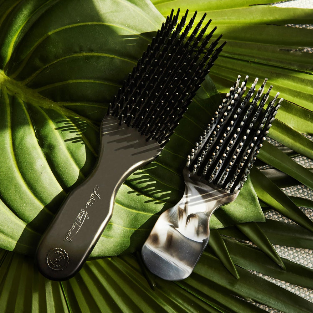 Leatherwood flexi-bristles detangler close-up showing fluid movement with hair.