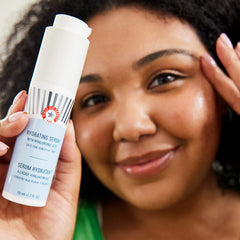 First Aid Beauty hydrating serum with squalane drop suggesting smooth, dewy skin