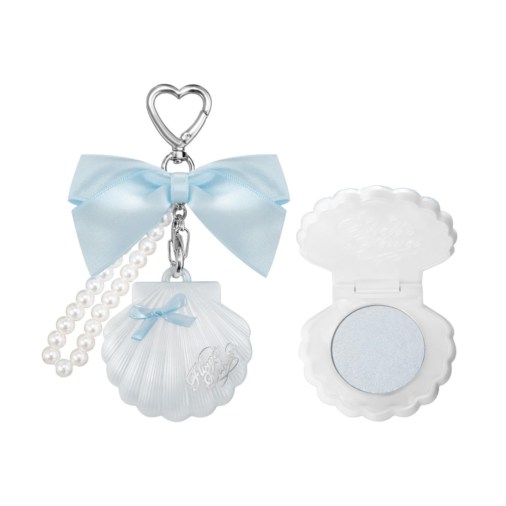 Flower Knows Shells Jewel Highlighter Balm in Blue Tears adds radiant cheek glow.
