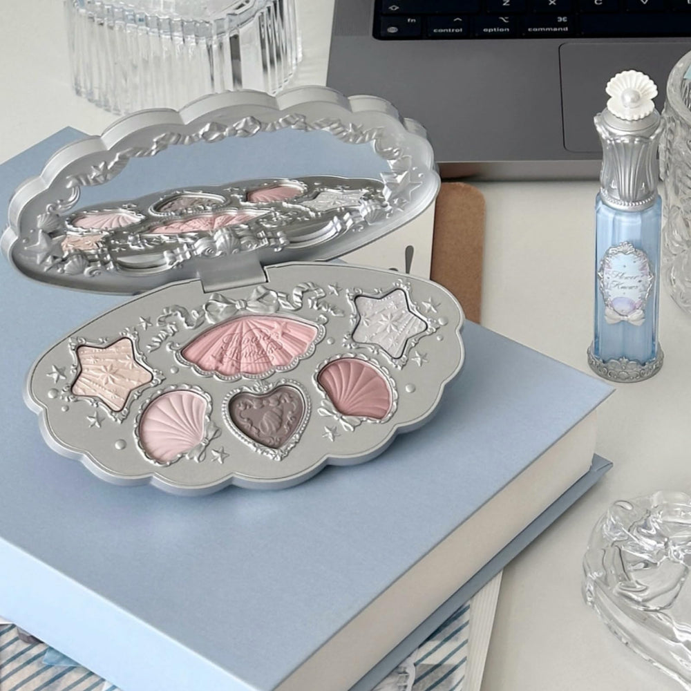 Flower Knows Shells Jewel Highlighter Balm Blue Tears adds cool-toned glow to cheeks or lids.