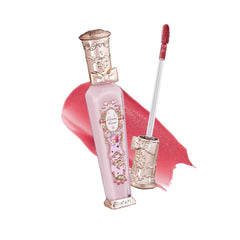 Flower Knows lip gloss bottle closeup with raspberry pink shimmer for party-ready glow