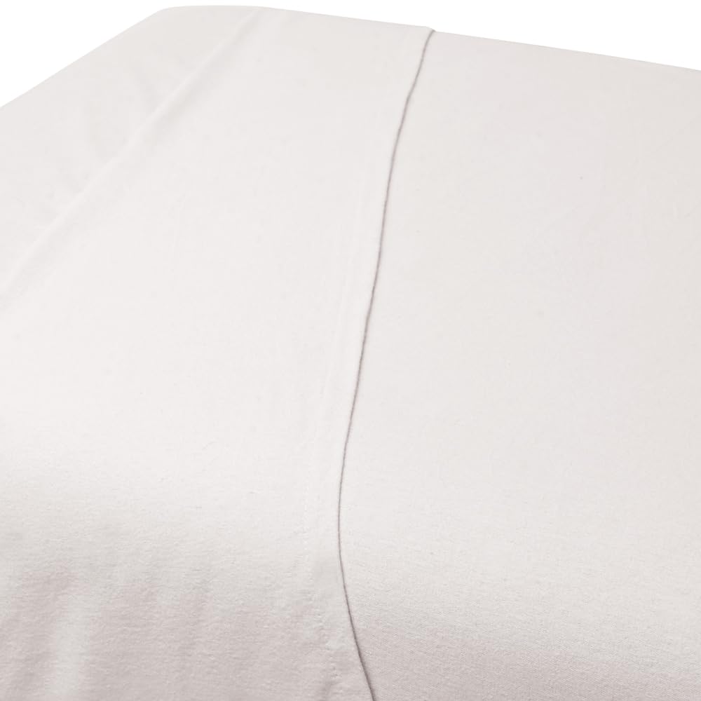 ForPro Premium Flannel Flat Sheet spread on a massage table showing a clean white finish for spa environments