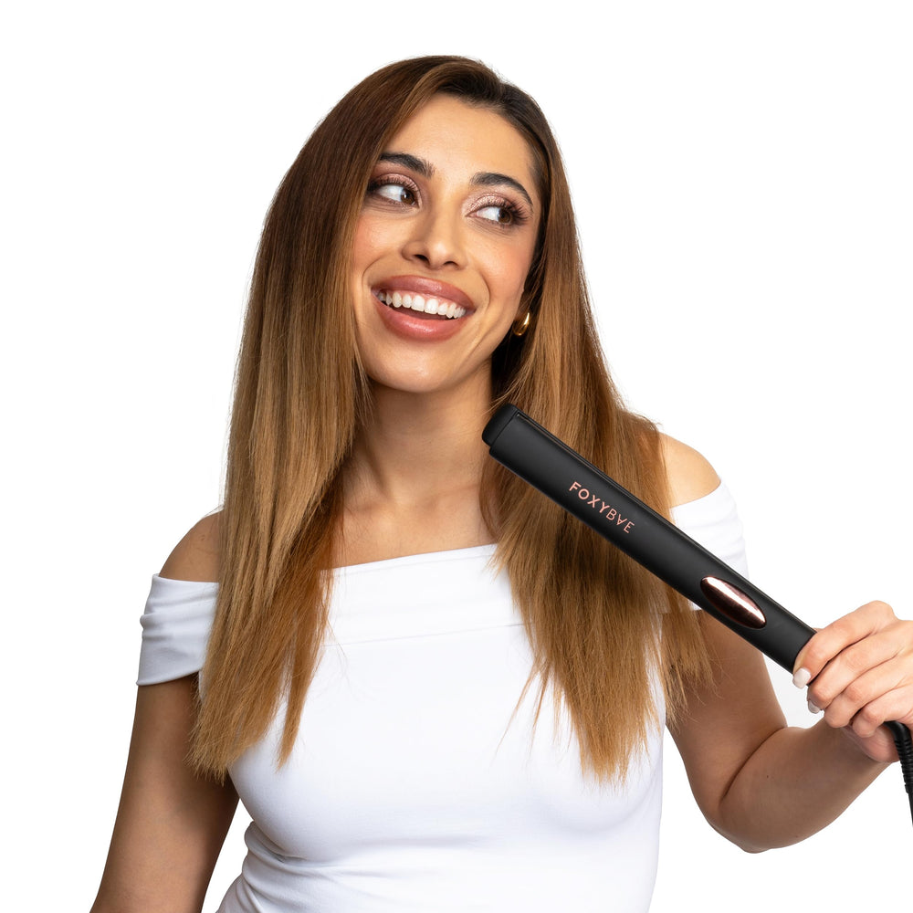 FoxyBae Trés Sleek flat iron in-hand demonstrates portable design.