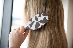 FRAMAR cow-print detangler brush bristles close-up for gentle knot removal