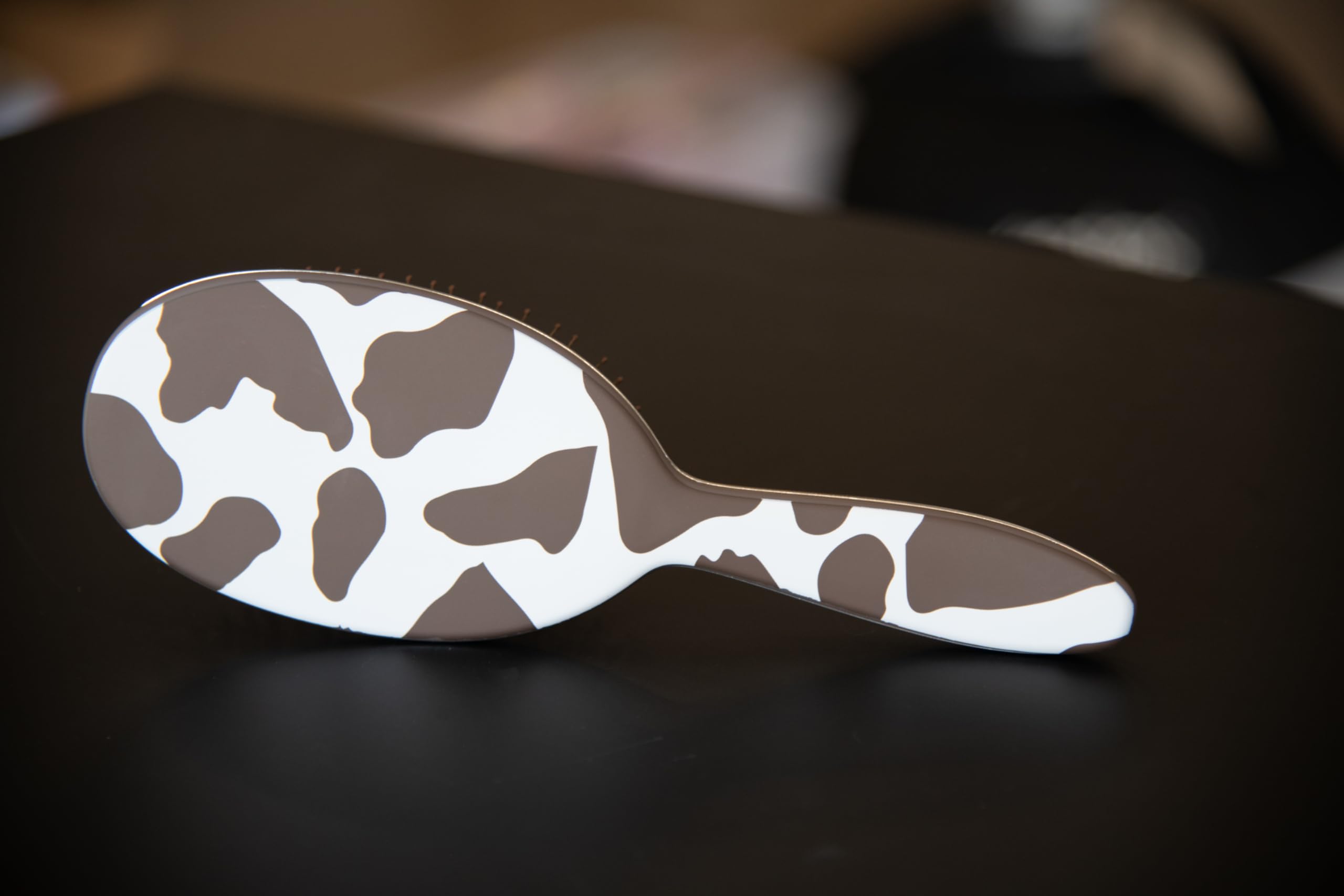 FRAMAR cow-print detangler on vanity top for quick mornings