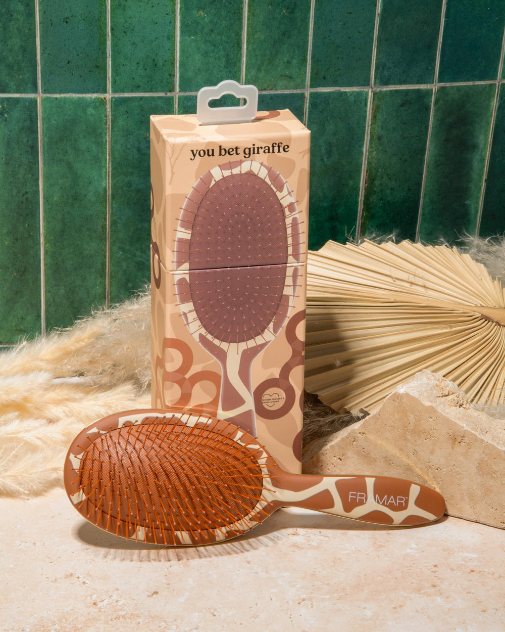FRAMAR giraffe-design hairbrush on vanity highlights stylish detangling for daily use.