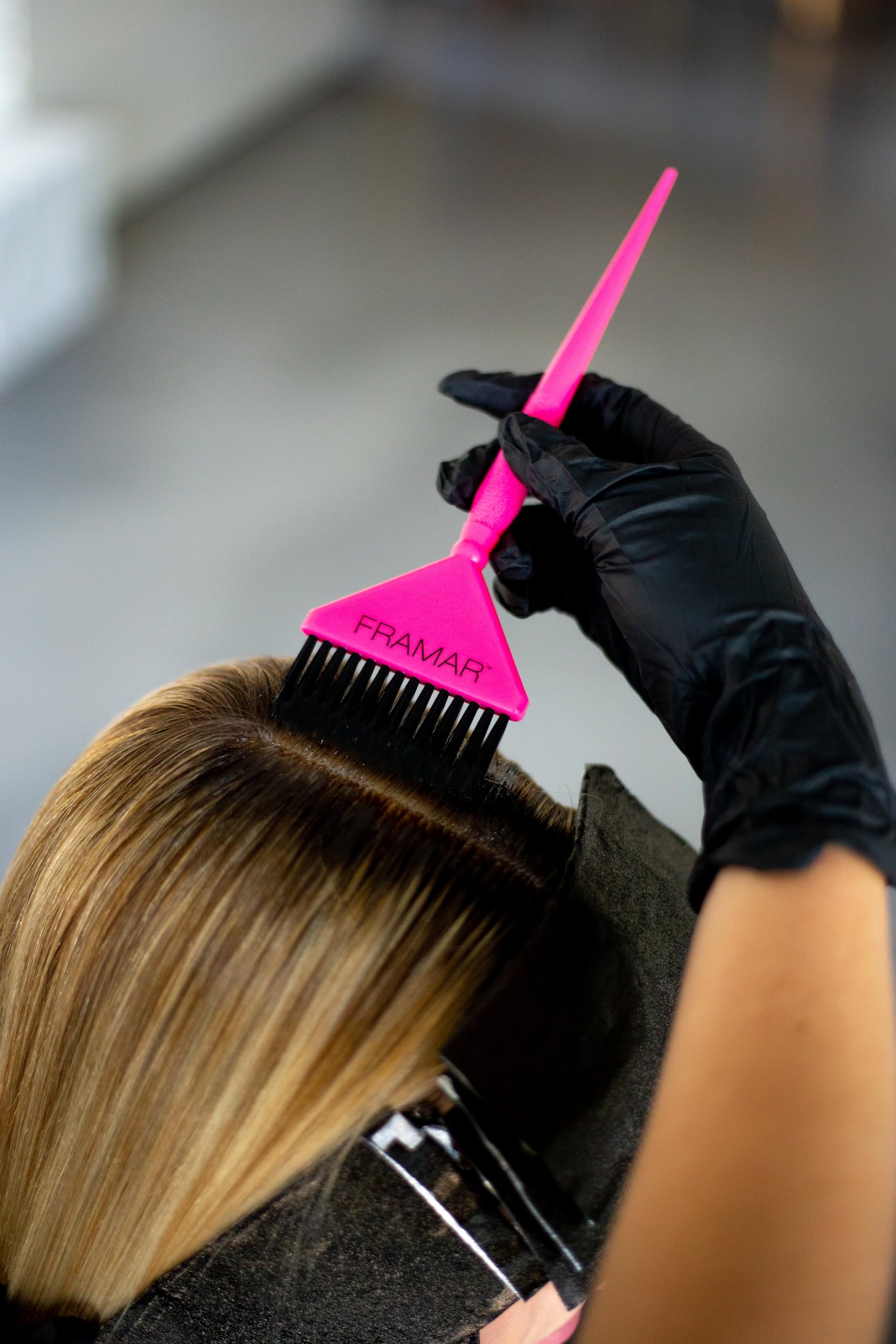 FRAMAR dye application with wide brush enhances efficiency during coloring.