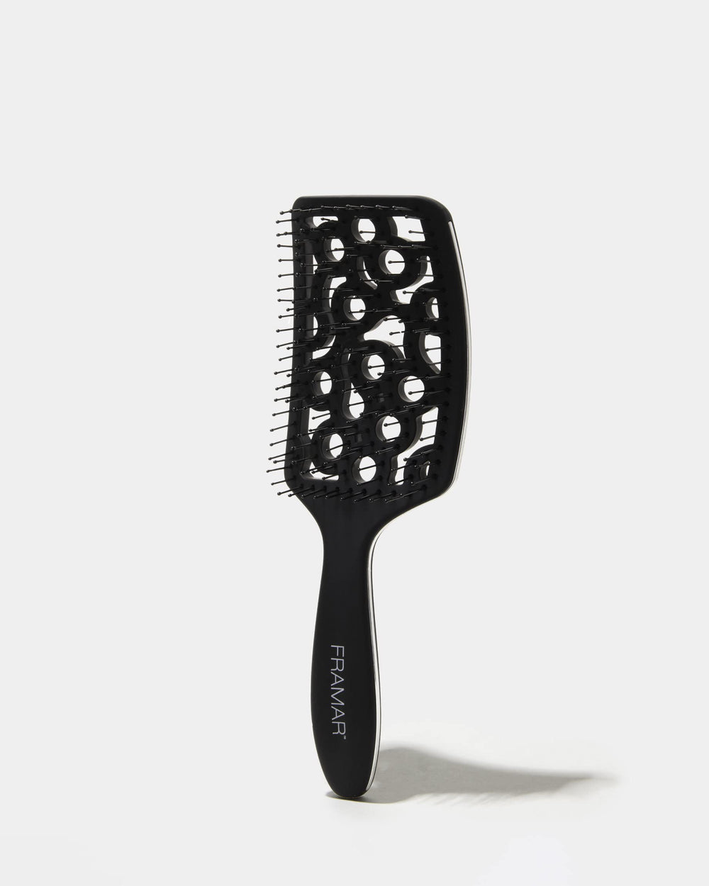 FRAMAR black vented brush shown in use for curated hair styling.