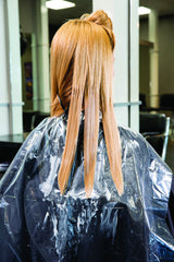 FRAMAR hair-cutting cape shields clients and furniture, keeping workstations tidy.